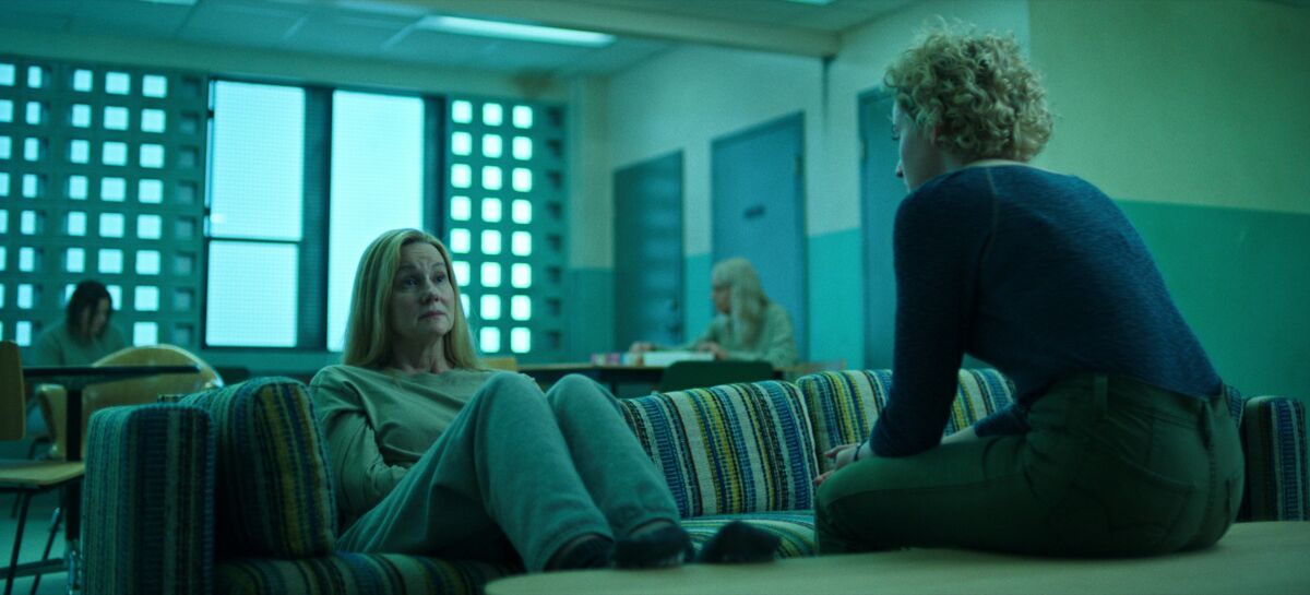 Two women sit facing each other talking in a scene from "Ozark."