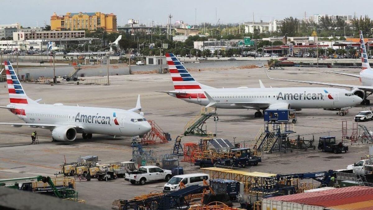 Two grounded American Airlines Boeing 737 Max 8 planes are parked at Miami International Airport on March 14.
