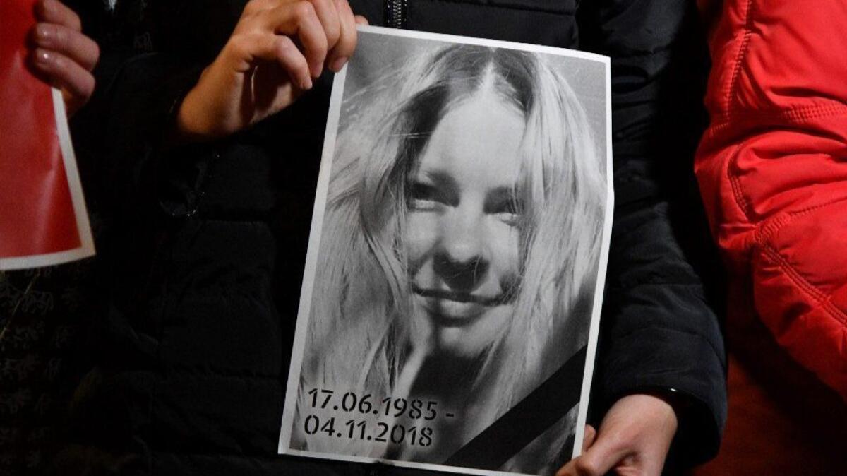 A woman holds a portrait of Kateryna Handzyuk in front of Ukraine's Interior Ministry during a Nov. 4 vigil for the anti-corruption campaigner. Handzyuk, 33, died in a Kiev hospital from injuries sustained in a July acid attack.