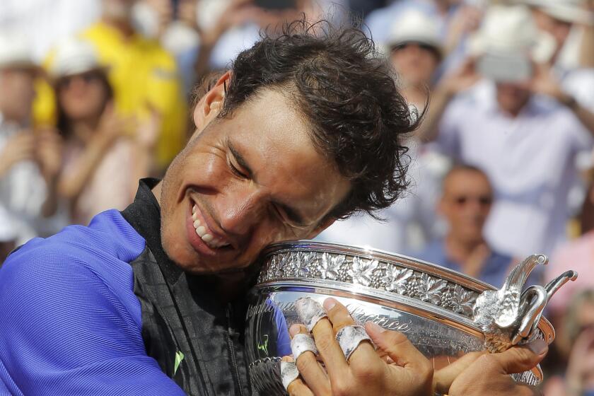 Spain's Rafael Nadal holds the cup after defeating Switzerland's Stan Wawrinka in their final match of the French Open tennis tournament at the Roland Garros stadium on June 11, 2017, in Paris.