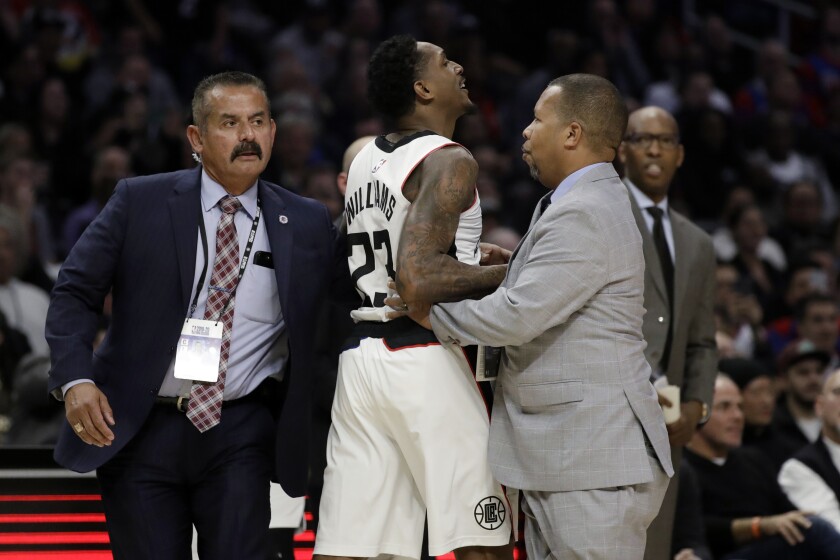 Clippers guard Lou Williams is held back after being ejected during the second half of a loss to the Houston Rockets on Dec. 19, 2019.