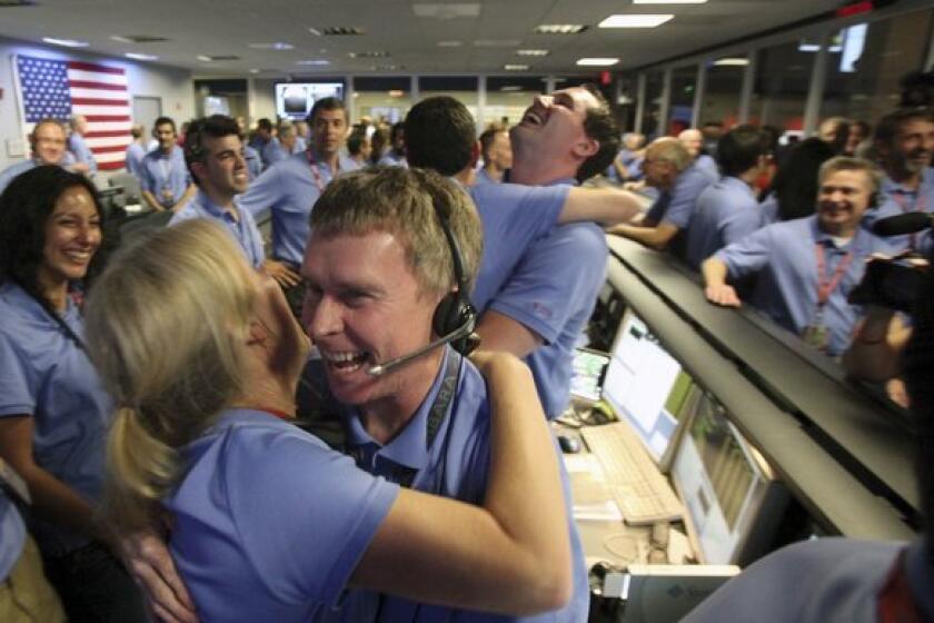 Curiosity survives the dreaded "Seven Minutes of Terror" and lands successfully on Mars. Staffers at the Jet Propulsion Laboratory in La Canada Flintridge (and people around the world) celebrate.