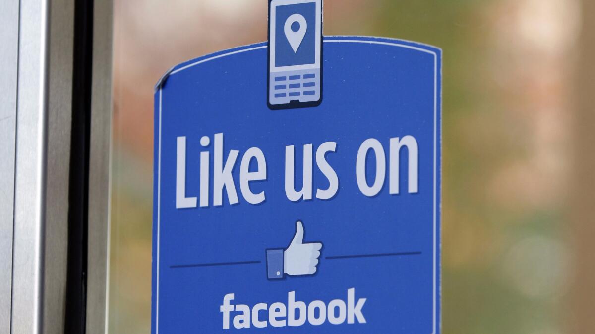 A sign with Facebook's "Like" logo is seen in Menlo Park, Calif. in 2011. Silicon Valley companies like Facebook employ economists and data scientists who work to develop algorithms based on user behavior.