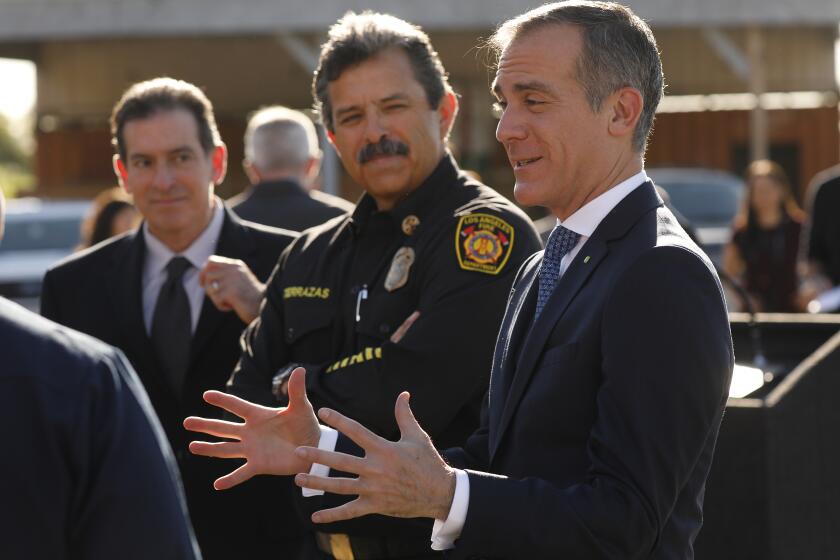 LOS ANGELES, CA - FEBRUARY 11, 2020 Los Angeles Mayor Eric Garcetti, right, with LA City Fire Department (LAFD) Chief Ralph Terrazas, left, talk to Firefighters before a press conference to announce the expansion of the LAFD’s Fast Response Vehicle (FRV) program. The LAFD now has four FRV’s in service citywide, which provide a flexible, multi- mission resource to respond to fire and emergency medical service calls. (Al Seib / Los Angeles Times)