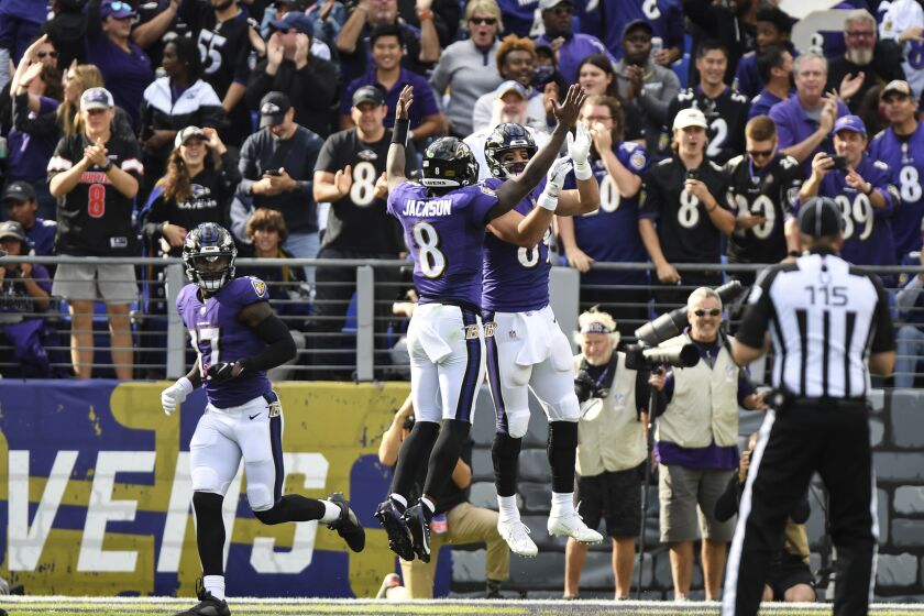 Baltimore Ravens quarterback Lamar Jackson (8) celebrates with tight end Mark Andrews after catching a third quarter touchdown pass to in an NFL football game against the Los Angeles Chargers, Sunday, Oct. 17, 2021, in Baltimore. (AP Photo/Terrance Williams)