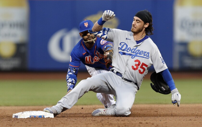 Dodgers slugger Cody Bellinger slides into second base ahead of the tag by the Mets' Jonathan Villar.