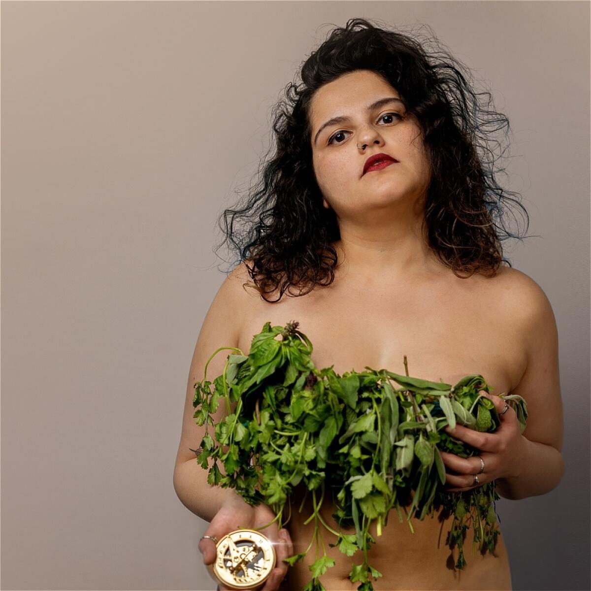 Indian-American comic Arzoo Malhotra holds a bunch of herbs.