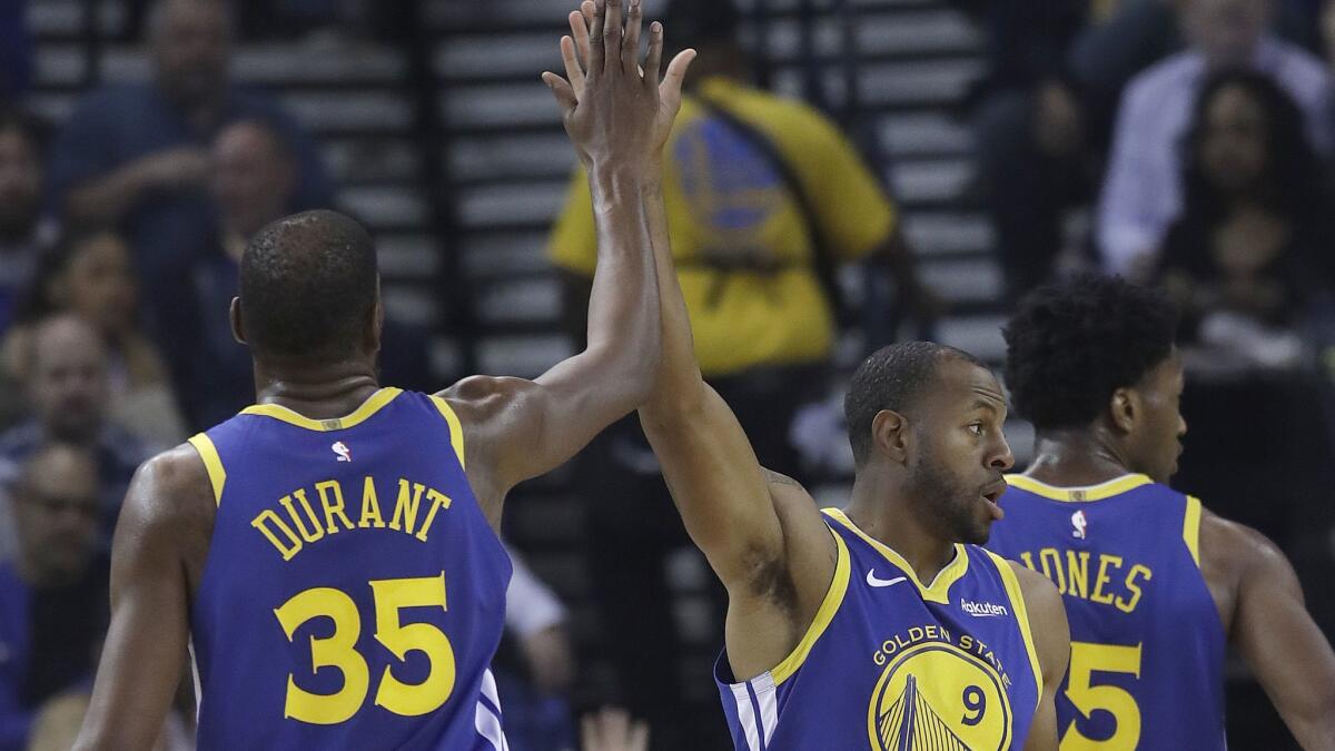 Golden State Warriors forward Kevin Durant (35) celebrates with forward Andre Iguodala (9) during the second half against the Brooklyn Nets on Saturday.