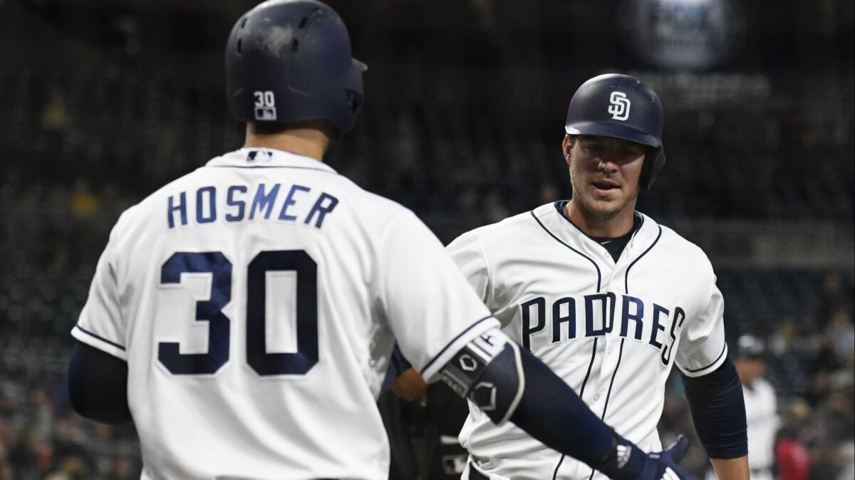 Wil Myers is congratulated by Eric Hosmer after hitting a solo home run in the first inning against the Colorado Rockies on Thursday night.