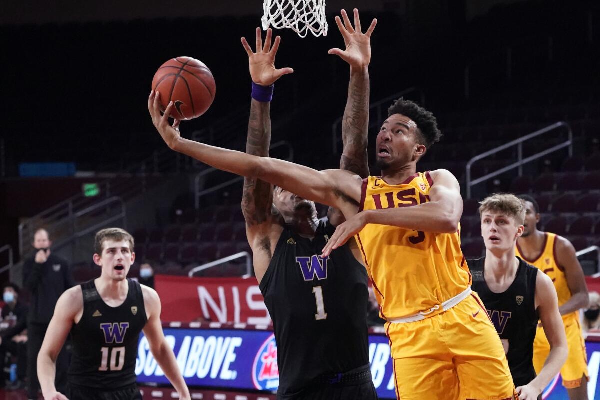 Southern California forward Isaiah Mobley, right, scores over Washington forward Nate Roberts.