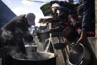 FILE - Palestinians line up for a free meal in Rafah, Gaza Strip, Friday, Feb. 16, 2024. President Joe Biden has proposed the delivery of humanitarian assistance to Gaza via a temporary port on the territory’s Mediterranean coast. (AP Photo/Fatima Shbair, File)