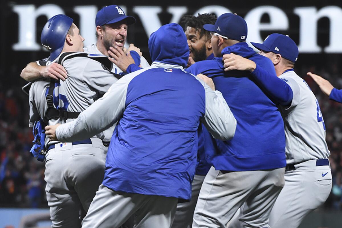 The Dodgers celebrate after defeating the Giants in Game 5 on Thursday.