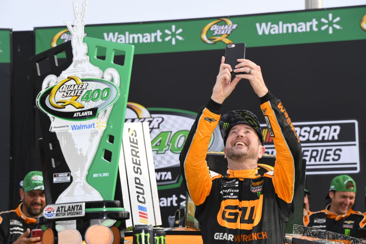 Kurt Busch celebrates in Victory Lane after winning a NASCAR Cup Series auto race, Sunday, July, 11, 2021, in Hampton, Ga. (AP Photo/John Amis)