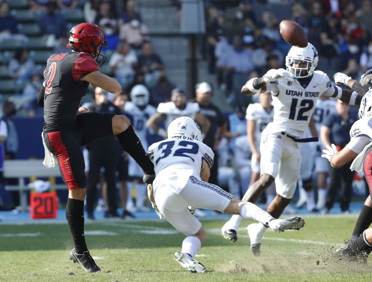 San Diego State's Matt Araiza has a punt blocked by Utah State's Reece Jarvis on Saturday in Mountain West title game.