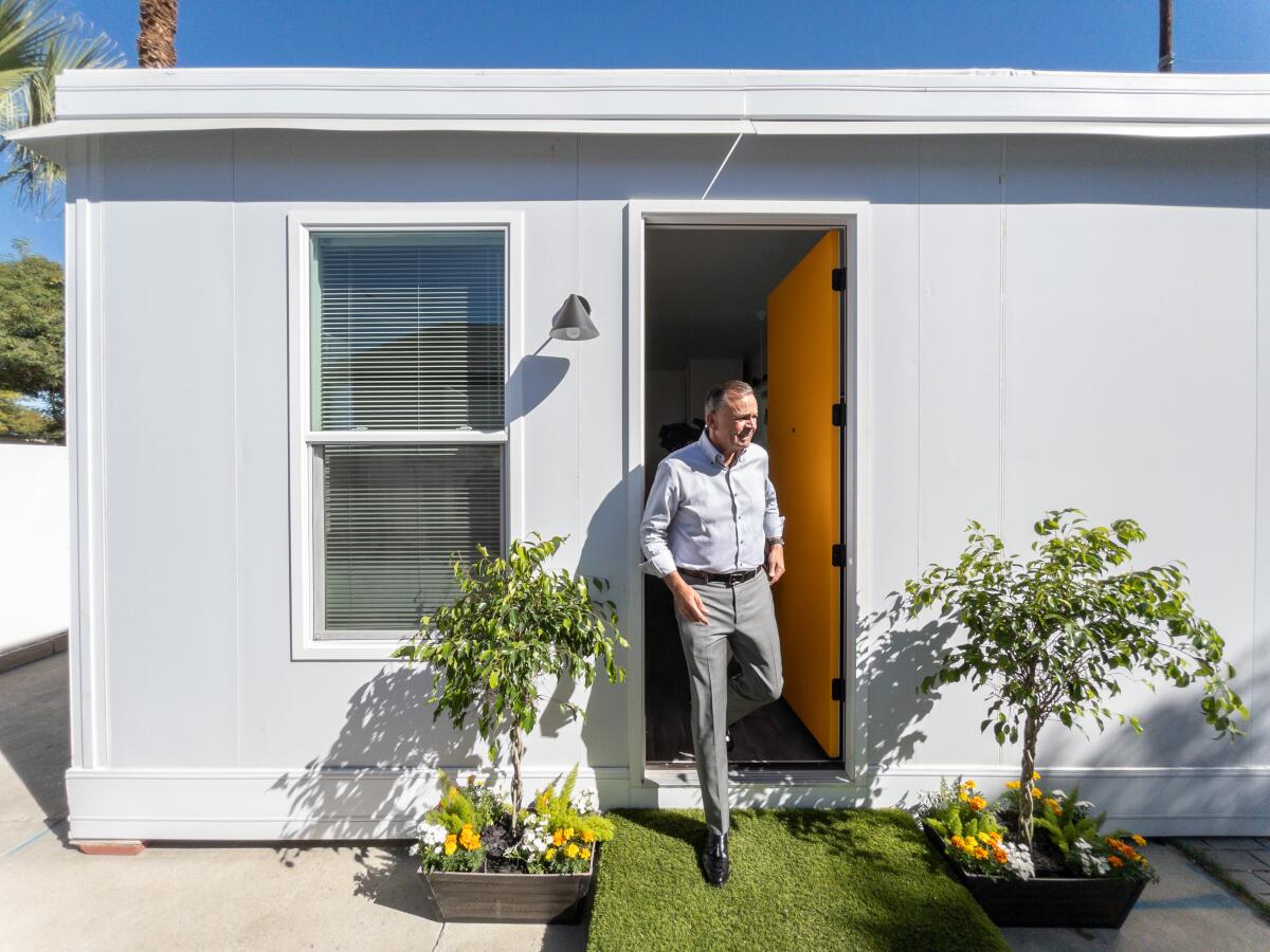 Rick Caruso exits a Boxabl unit, a form of low-cost housing.