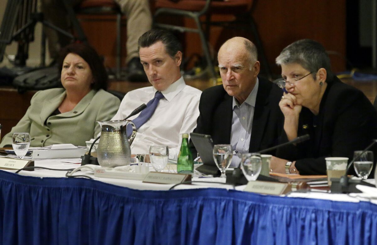 Assembly Speaker Toni Atkins, left, Lt. Gov. Gavin Newsom, Gov. Jerry Brown, and University of California President Janet Napolitano listen during the public comments portion of the UC regents meeting in November.
