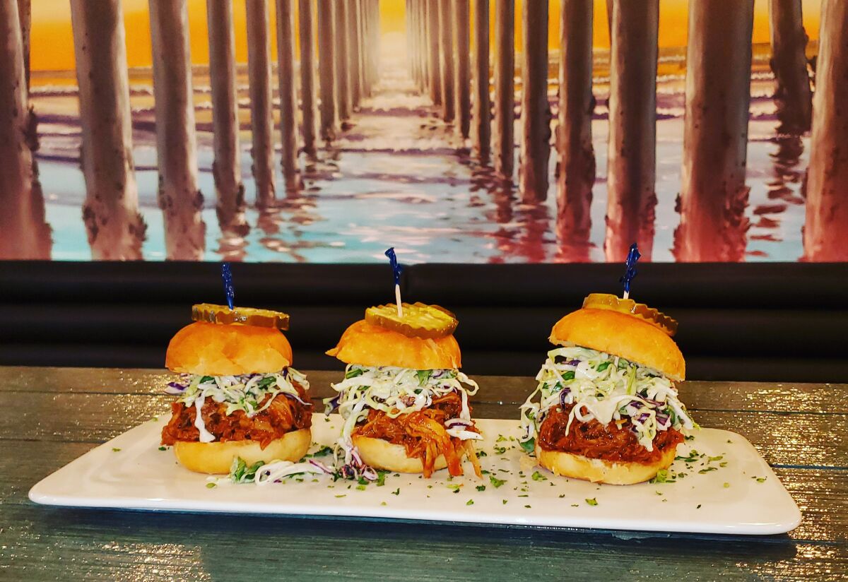 BBQ Pulled-Pork Sliders with slaw and pickles, under the Crystal Pier mural.