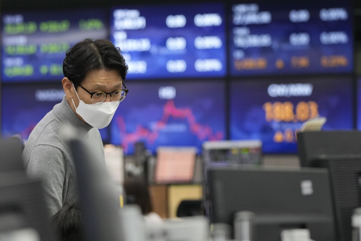 A currency trader watches monitors at the foreign exchange dealing room of the KEB Hana Bank headquarters in Seoul, South Korea, Friday, Feb. 11, 2022. Shares were mostly lower Friday in Asia after a sell-off on Wall Street spurred by news that U.S. inflation jumped 7.5% in January, which raised expectations the Federal Reserve will need to move forcefully to cool the economy by raising interest rates. (AP Photo/Ahn Young-joon)