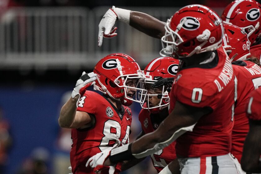 Georgia wide receiver Ladd McConkey (84) celebrates a touchdown with his teammates in the first half of the Southeastern Conference championship NCAA college football game against LSU, Saturday, Dec. 3, 2022, in Atlanta. (AP Photo/Brynn Anderson)