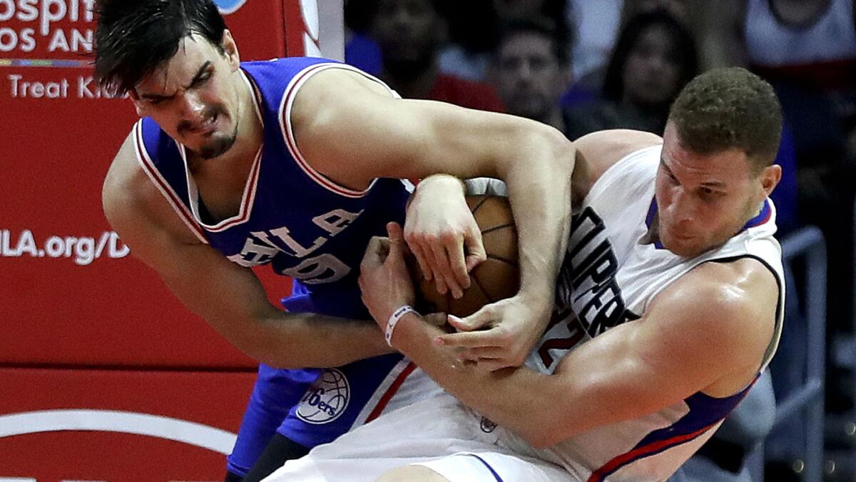 Clippers forward Blake Griffin battles 76ers forward Dario Saric for a rebound during the second half Saturday.