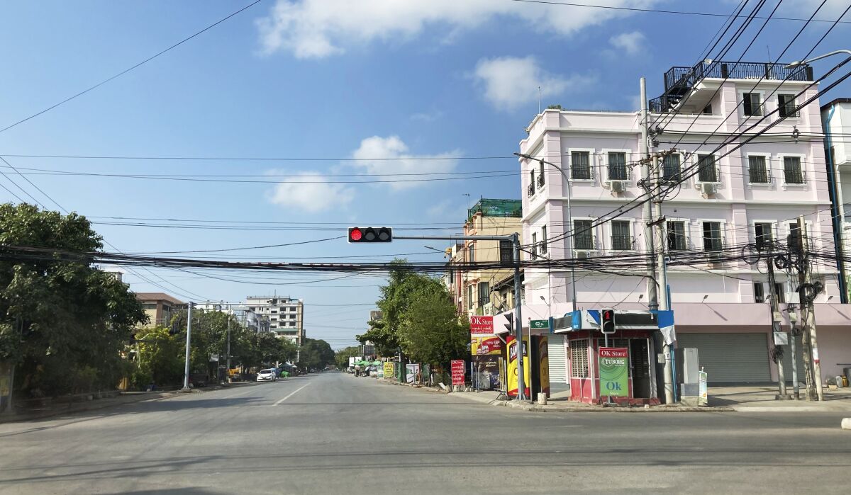An empty street is seen Friday, Dec. 10, 2021, in Mandalay, central Myanmar. Streets were seen empty in Mandalay Friday as people participated in a "silent strike" to mark International Human Rights Day. Many offices, shops and restaurants were closed and people stayed indoors in protest of the military takeover. (AP Photo)