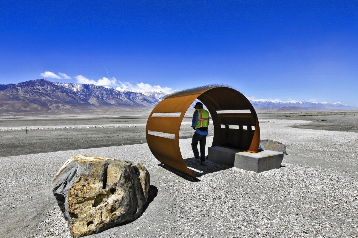 Michael Prather, a Lone Pine botanist and co-founder of the Owens Lake Bird Festival, checks a specially designed metal structure for bird viewing along the trails at the lake.