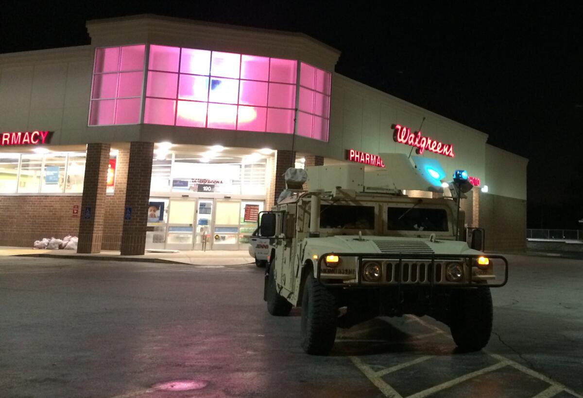 A Humvee sits outside a Walgreens in Ferguson, Mo., while the Missouri National Guard spread out to watch over parts of the St. Louis suburb. Thanksgiving was a calm day for the area.