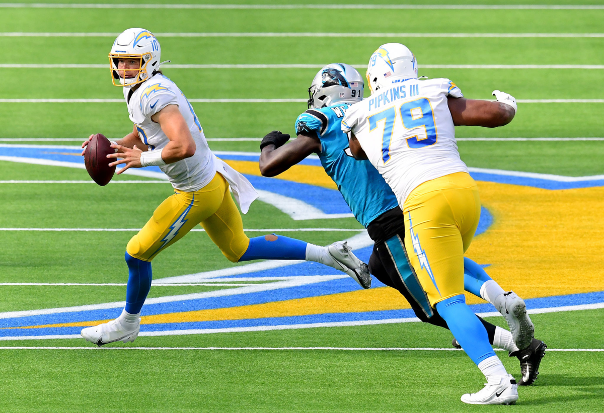 Chargers quarterback Justin Herbert rolls out of the pocket during last week's loss to the Carolina Panthers.