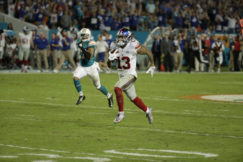 Giants wide receiver Odell Beckham (13) runs for a touchdown against the Dolphins during the second half.
