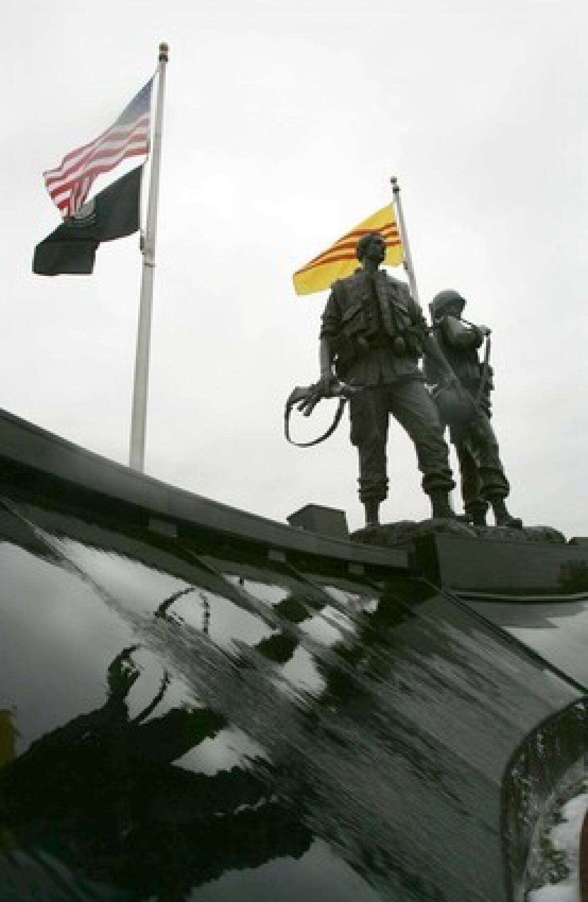  A Vietnam veteran traces a name on the Vietnam Veterans Memorial