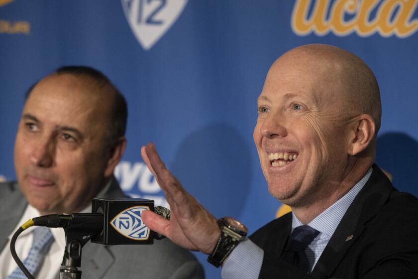 WESTWOOD, CALIF. -- WEDNESDAY, APRIL 10, 2019: UCLA Director of Athletics Dan Guerrero, left, and Mick Cronin, right, the new UCLA Men?s Head Basketball Coach during a press conference in Westwood, Calif., on April 10, 2019. (Brian van der Brug / Los Angeles Times)