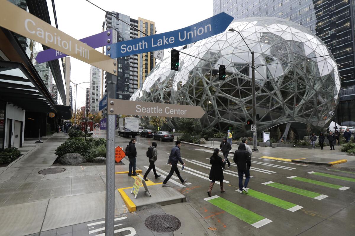 The Amazon Spheres in downtown Seattle. Signs point the way to the city's South Lake Union and other neighborhoods.