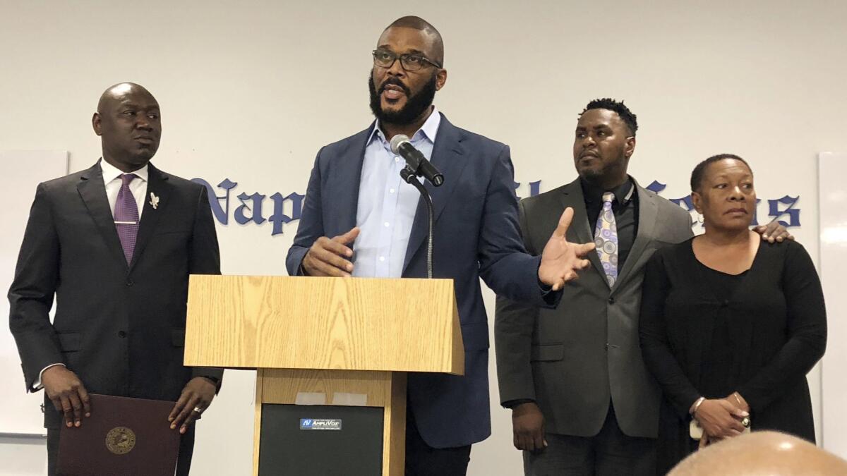 Filmmaker Tyler Perry speaks during a news conference announcing a lawsuit against former Collier County Sheriff's Deputy Steven Calkins in the 2004 disappearance of Terrance Williams. WIlliams' mother, Marcia Williams is on the right.