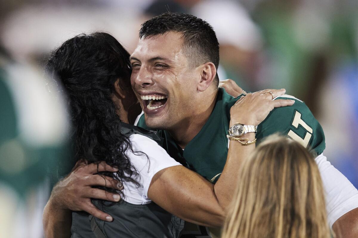 Charlotte quarterback Chris Reynolds is congratulated by fans after a win over Duke on Sept. 3, 2021.