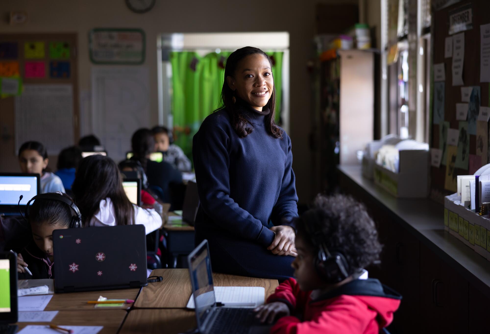 Teacher Tyara Brooks stands by a classroom window.