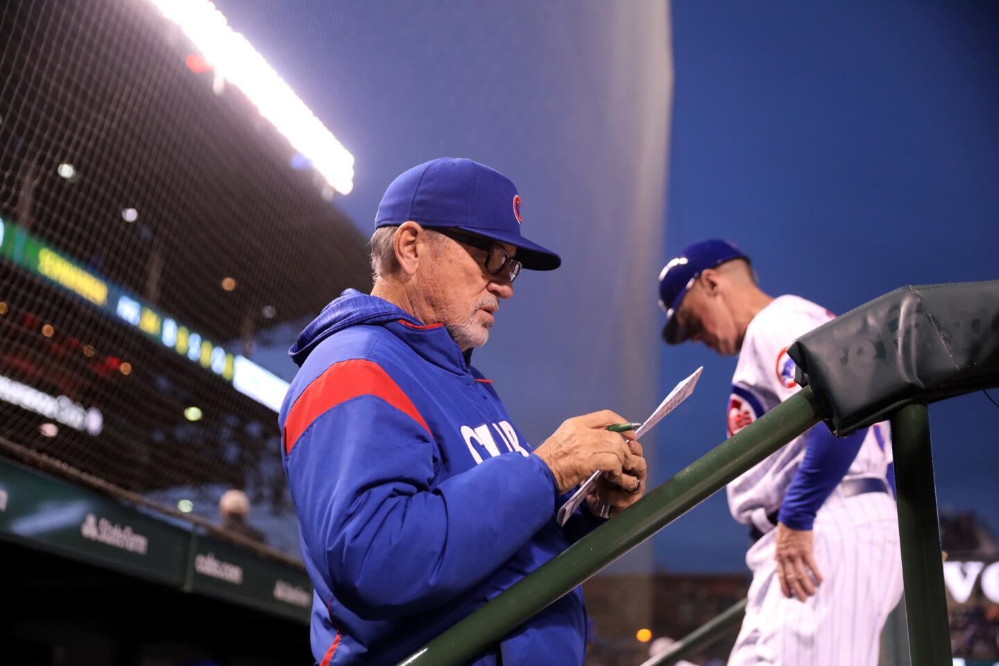 Cubs manager Joe Maddon stands in the dugout in the seventh inning of a game against the Brewers at Wrigley Field on Thursday, April 26, 2018.