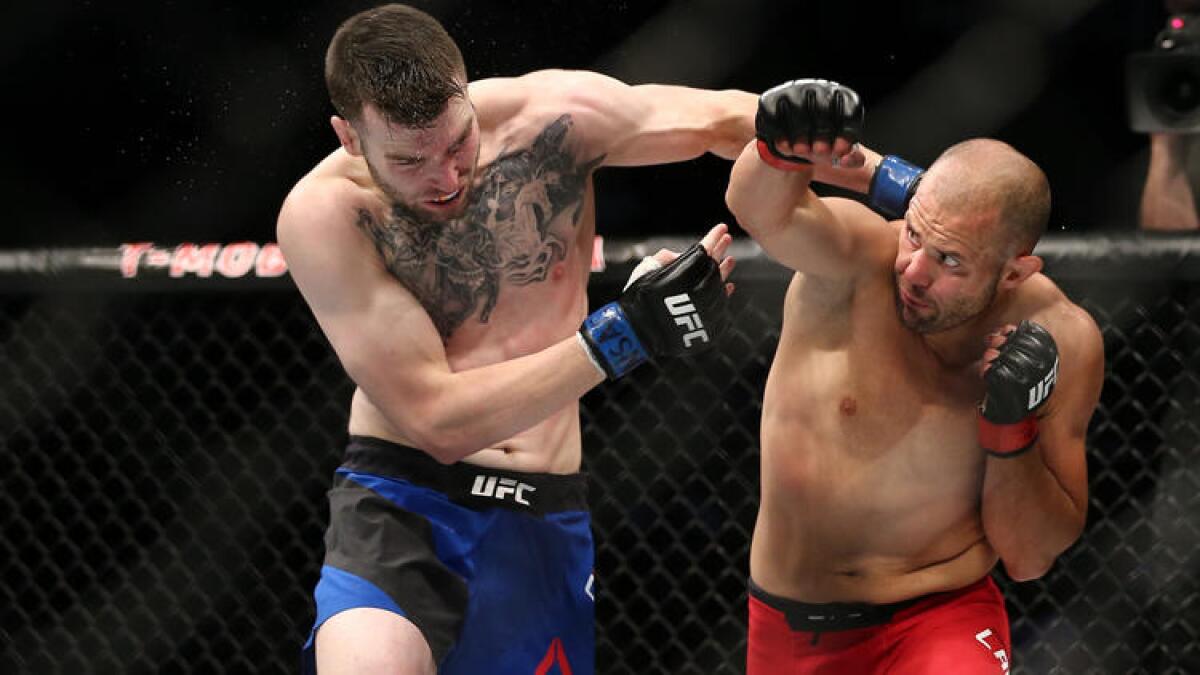 Brian Camozzi, left, and Chad Laprise trade punches during their welterweight bout at UFC 213.