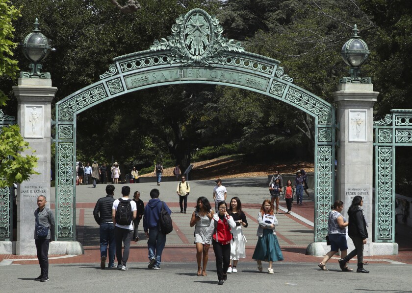The UC Berkeley campus with people walking through Sather Gate