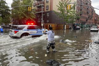 A man works to clear a drain in flood waters, Friday, Sept. 29, 2023, in the Brooklyn borough of New York. A potent rush-hour rainstorm has swamped the New York metropolitan area. The deluge Friday shut down swaths of the subway system, flooded some streets and highways, and cut off access to at least one terminal at LaGuardia Airport. (AP Photo/Jake Offenhartz)