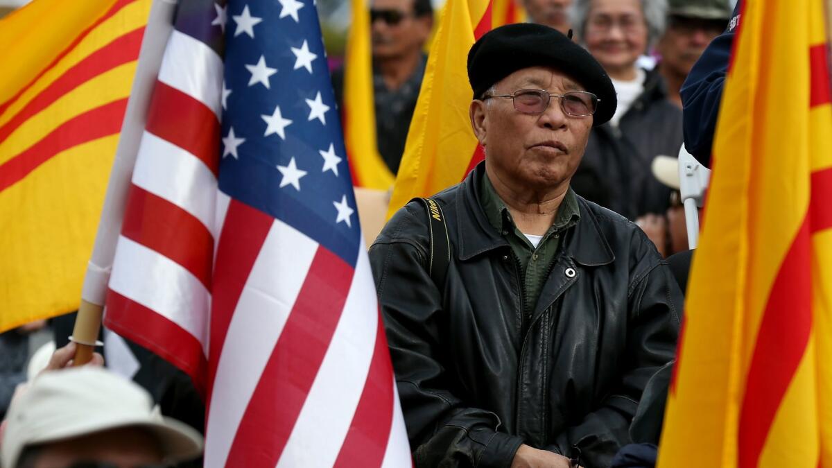 Members of the Vietnamese American community listen to state Sen. Janet Nguyen at a rally in Westminster.