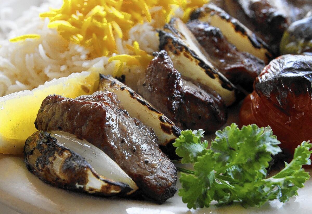 The lamb kabob comes with rice and grilled onions, tomato and pepper at The Olive Branch in the 3600 block of Foothill Boulevard in La Crescenta, on Thursday, Feb. 27, 2014.