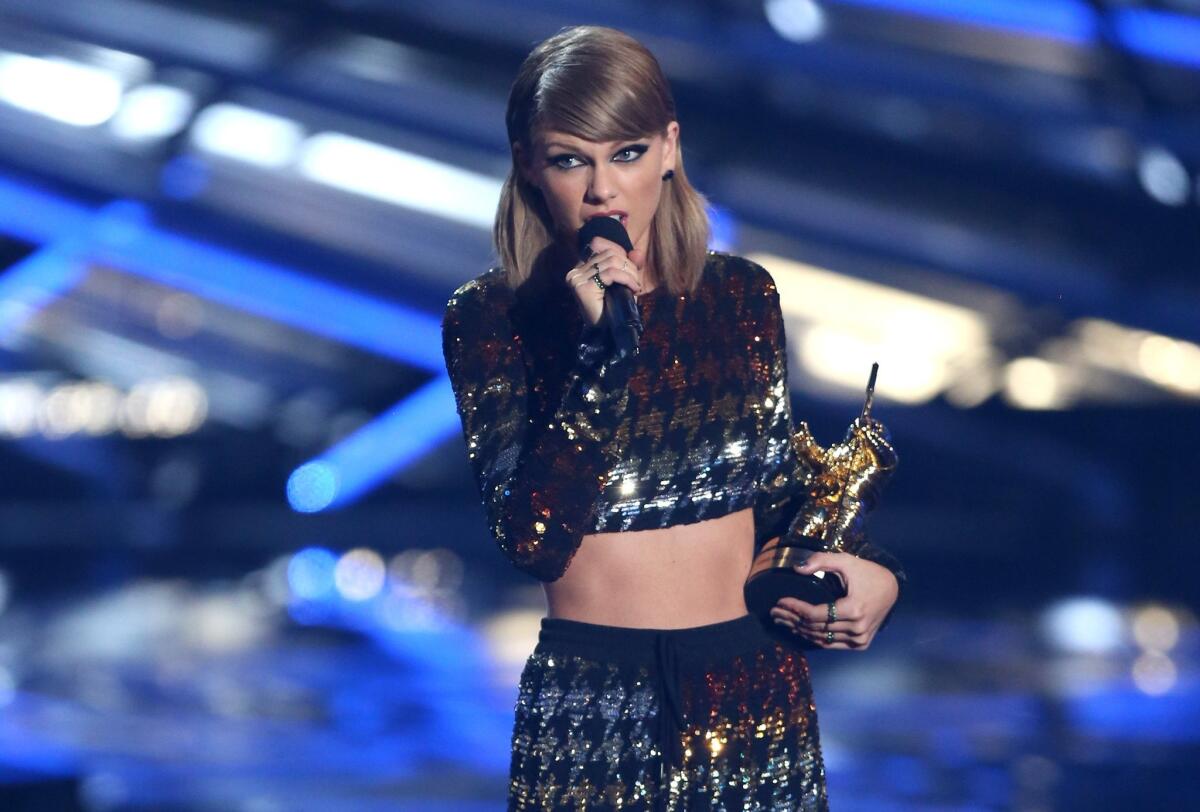 Taylor Swift appears at the MTV Video Music Awards in Los Angeles on Sunday. A man who allegedly rushed the stage during her concert Saturday in San Diego is facing six criminal charges.