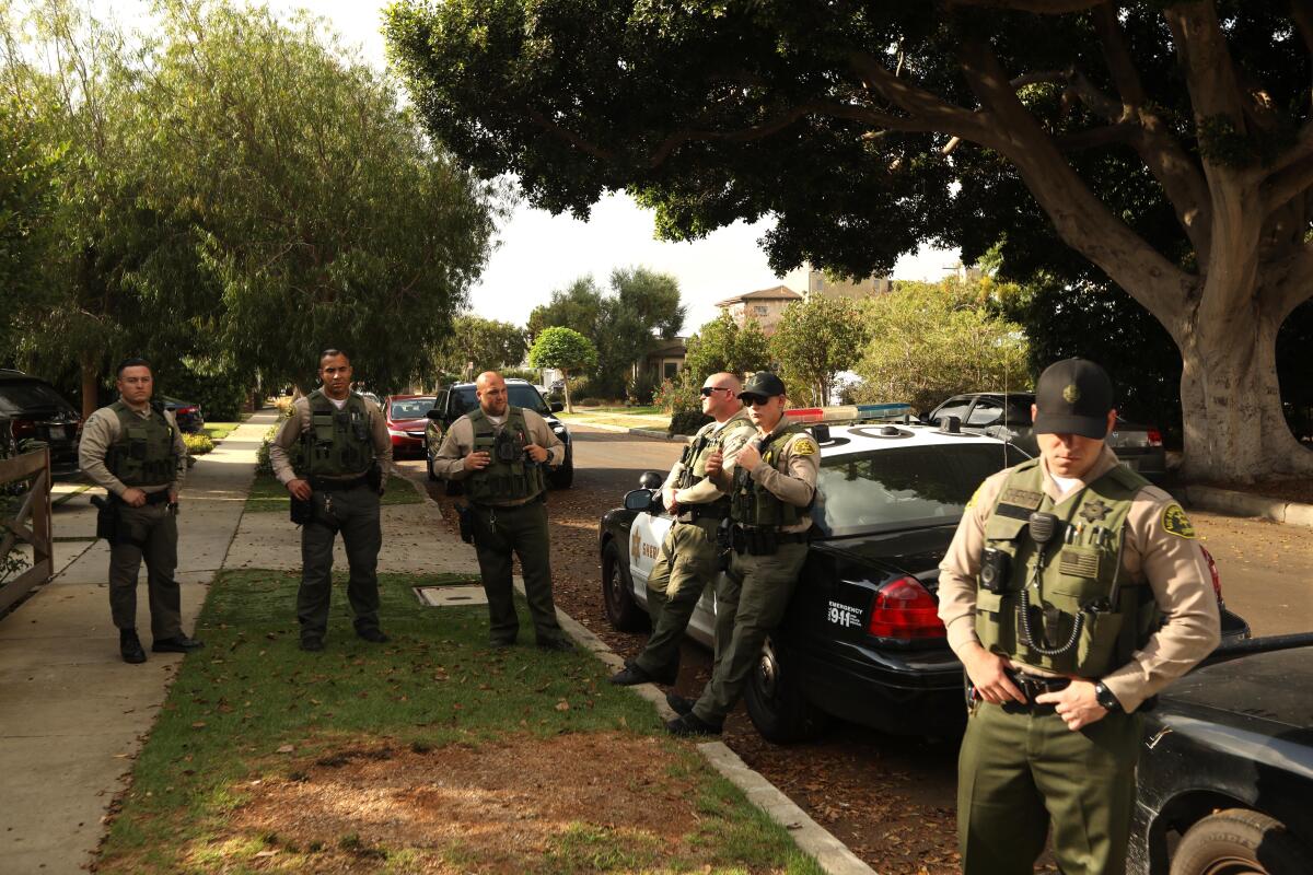 Sheriff's deputies outside the Mar Vista home of Patti Giggans during the search of her home.