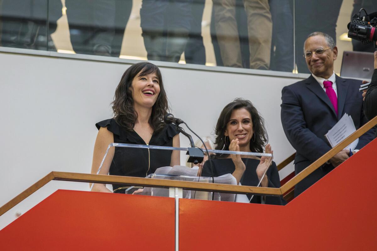 New York Times staff writers Megan Twohey, left, and Jodi Kantor address colleagues in the newsroom after winning a Pulitzer Prize.