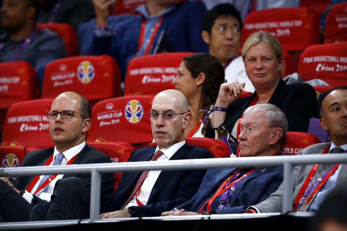 NBA Commissioner Adam Silver, second from left, attends the semifinal match between Argentina and France in the FIBA Basketball World Cup.