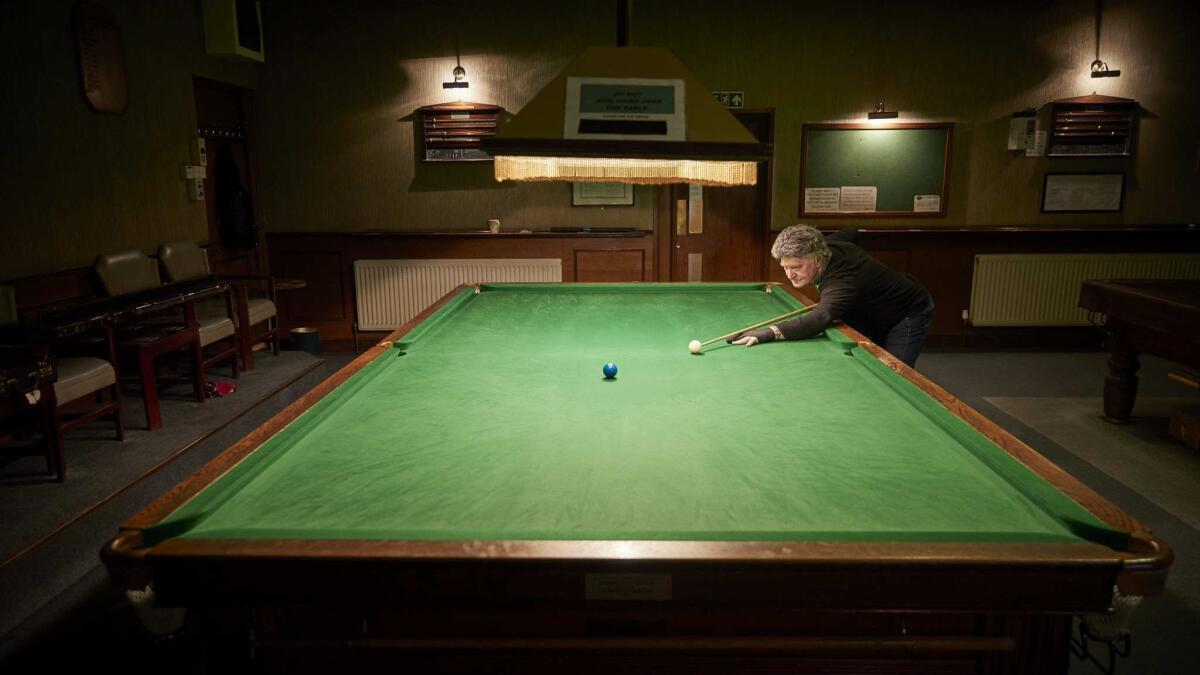 Tony Gilligan, 76, practices snooker at the Hornchurch Conservative Club.