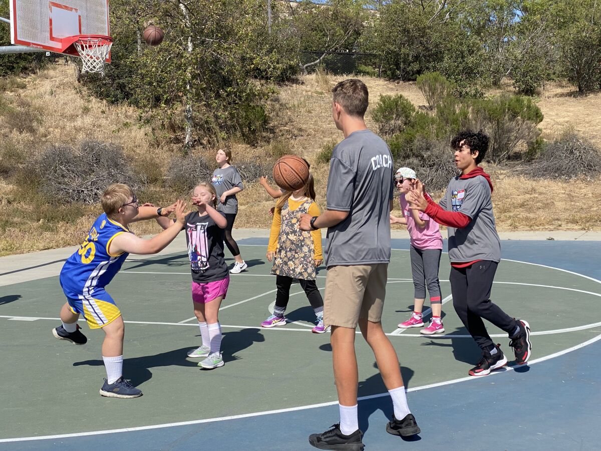 Coaches and participants in Ezra Granet's San Diego Chill Out play basketball.