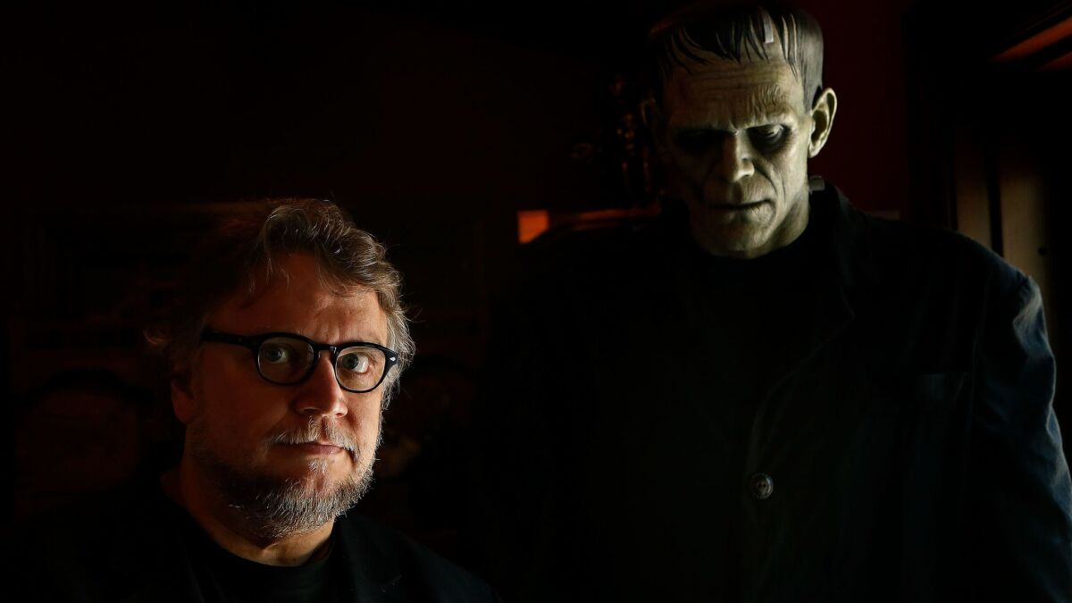 Director Guillermo del Toro stands with a sculpture of Boris Karloff as Frankenstein’s monster in 2016 in the Westlake Village home he's dubbed Bleak House.