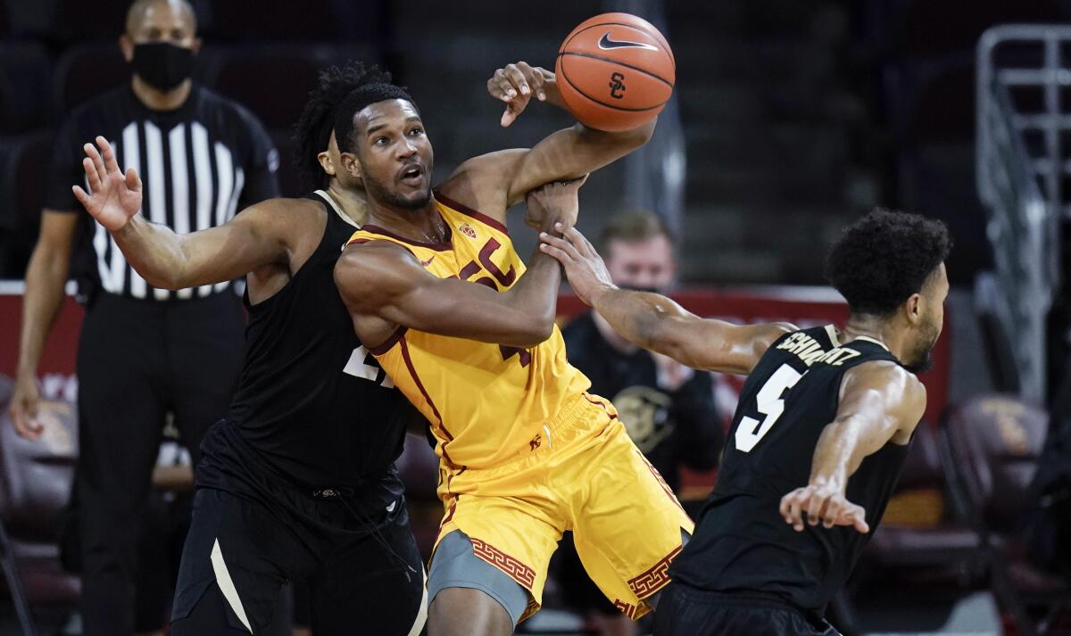 USC's Evan Mobley is fouled by Colorado's D'Shawn Schwartz during the first half of Thursday's game.