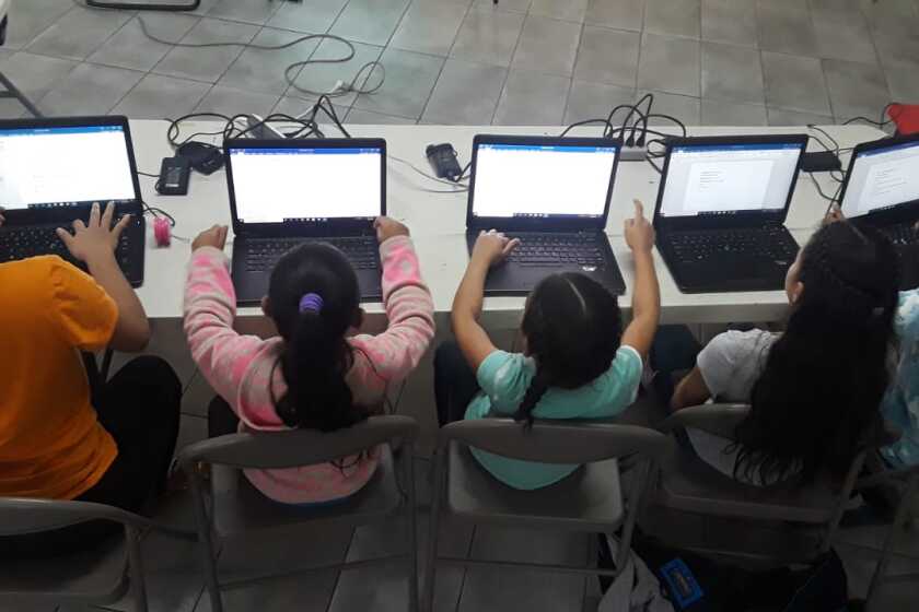Girl at Tijuana migrant shelter Espacio Migrante learn basic computer skills through a program made in partnership with Create Purpose and UC San Diego.